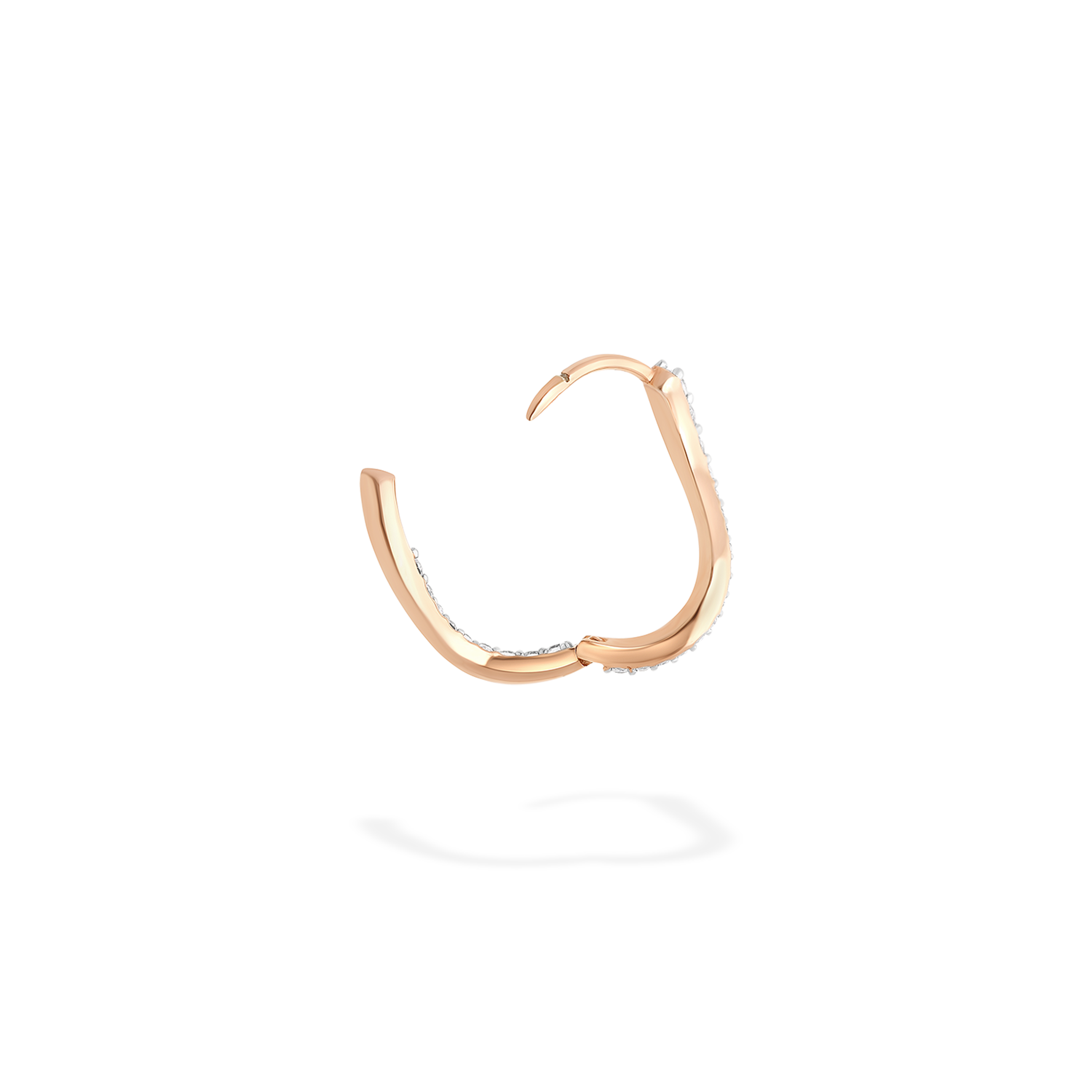 The hoop earring presented here in profile. This piece is crafted in 18k rose gold and set with natural diamonds. This jewel and its undulations are inspired by the Caustics, the luminous phemonem of light meeting water. It opens thanks to a secured clip mechanism.