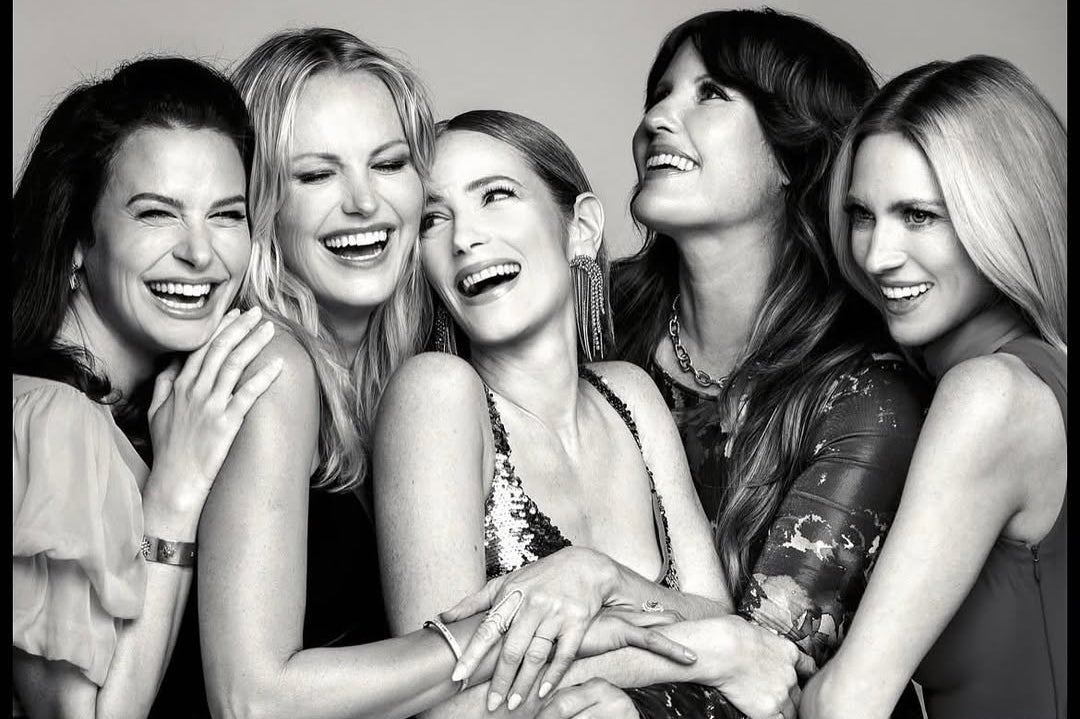 In this black-and-white portrait from the Netflix Emmy party, Jaime Ray Newman and the women around her showcase an assortment of statement rings and distinctive ear jewelry. From sculptural ring designs to delicate, shimmering ear cuffs and earrings, the pieces bring varied shapes and elegant details to the group portrait.