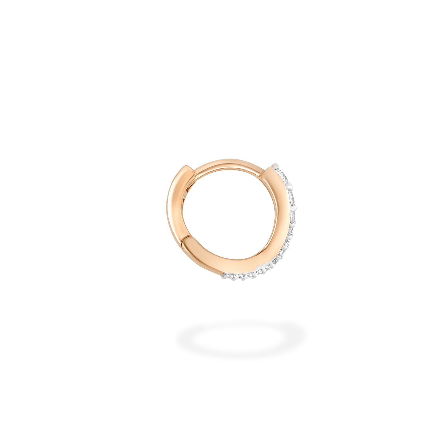 A mini hoop earring presented here in profile. This piece is crafted in 18k rose gold and set with natural diamonds. This jewel and its undulations are inspired by the Caustics, the luminous phemonem of light meeting water.