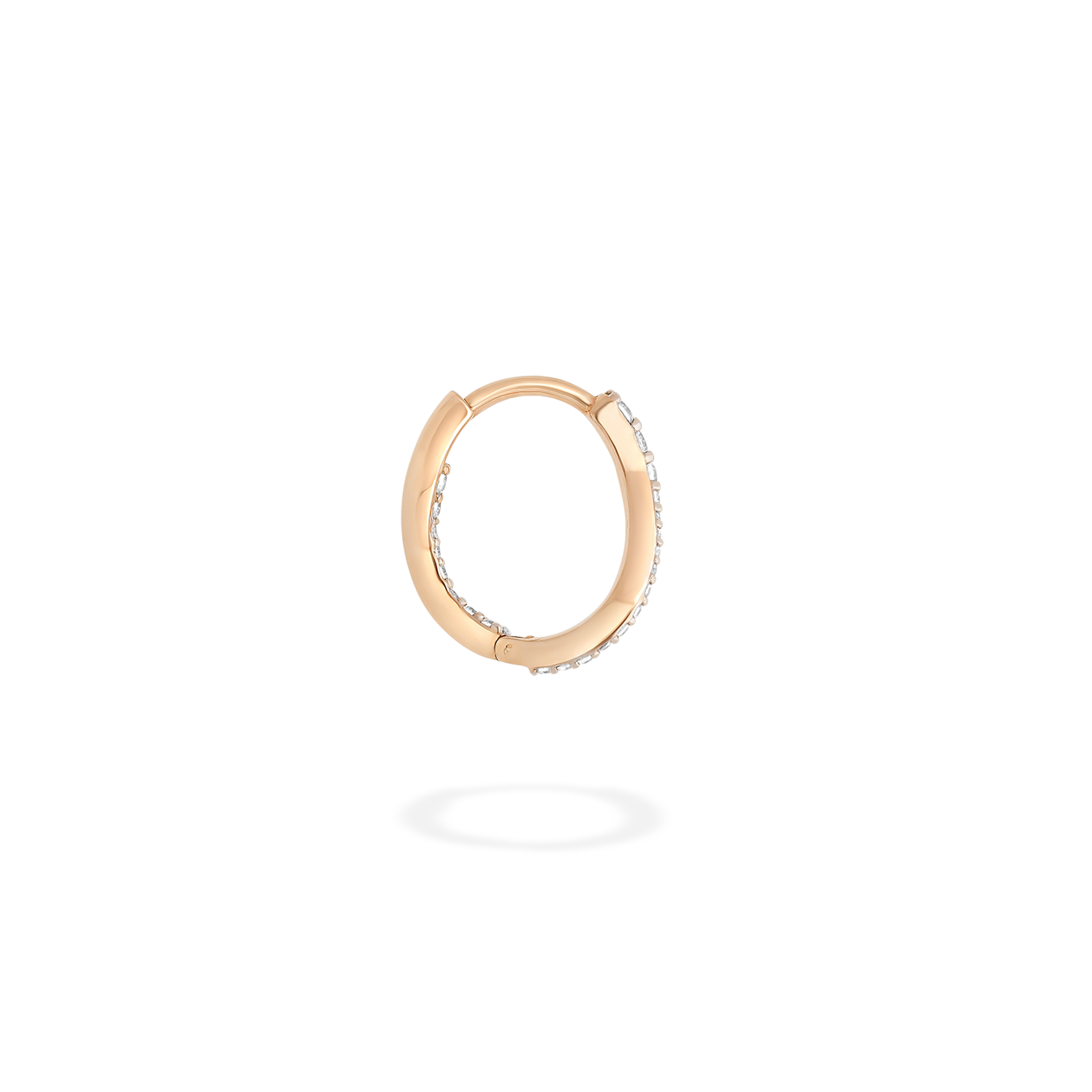 The petite hoop earring presented here in profile. This piece is crafted in 18k rose gold and set with natural diamonds. This jewel and its undulations are inspired by the Caustics, the luminous phemonem of light meeting water.